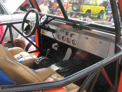 1968 Ford Mustang - The interior of a custom off-road vehicle features a roll cage and a dashboard with multiple gauges.