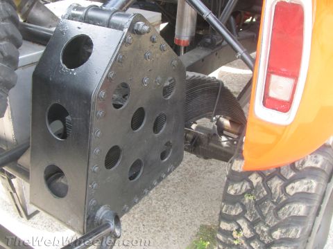 1968 Ford Mustang - Close-up of off-road vehicle's rear suspension and a protective plate.