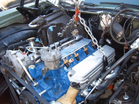 1973 Ford Ranchero - Engine assembly suspended by a chain hoist, ready for installation or removal.