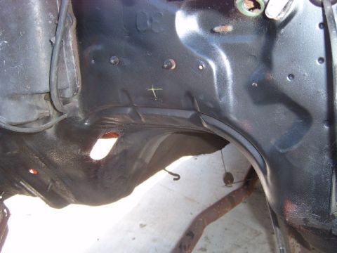 1973 Ford Ranchero - Close-up view of a vehicle's undercarriage frame, showing structural components and some surface rust.