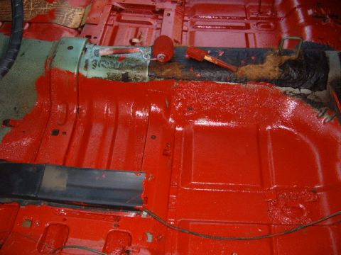 1973 Ford Ranchero - The interior floor pan of a 1973 Ford Ranchero is being painted red, with rollers and brushes visible.