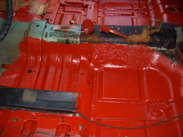 1973 Ford Ranchero interior floor pan painted red with rollers