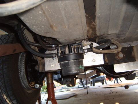 1973 Ford Ranchero - The fuel filter assembly is mounted beneath the vehicle, connected to the fuel tank via hoses.