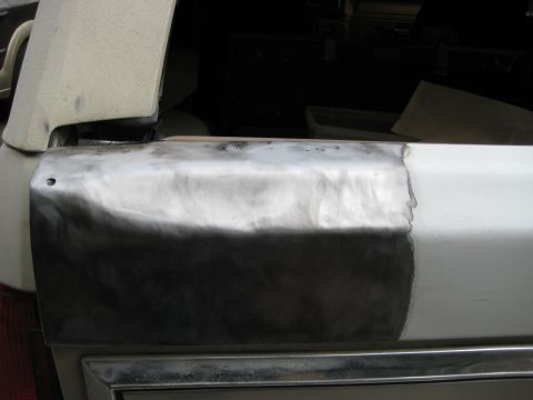 1980 Ford Bronco - Car door undergoing repair, showing a patch of bare metal and primer.