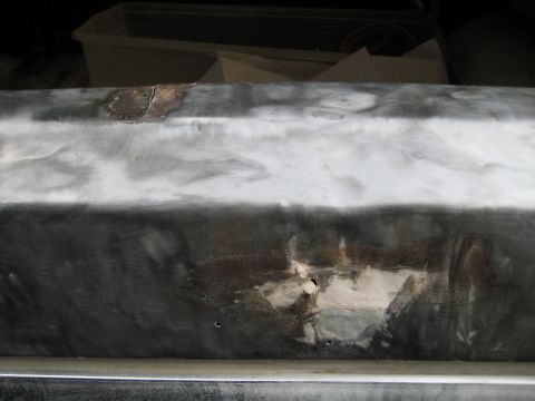 1980 Ford Bronco - This image shows a vehicle body panel undergoing repair work, with visible rust and filler material.