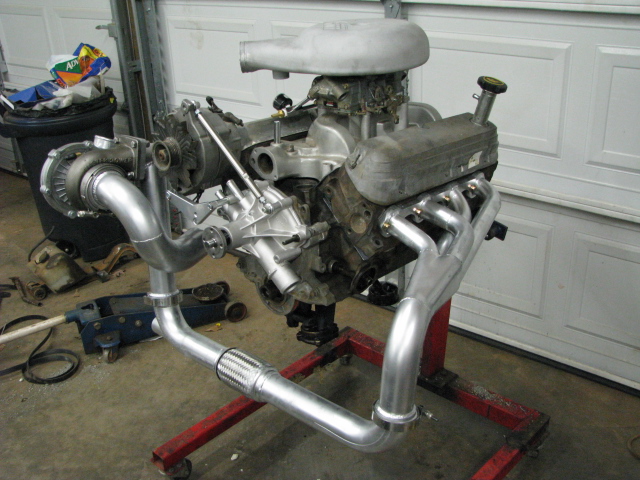 Engine on stand with turbocharger and custom exhaust pipes