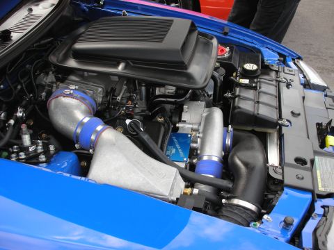 1992 Ford Crown Victoria - Customized engine bay a turbocharger and prominent intercooler piping, likely for performance enhancement.