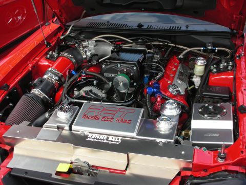 1992 Ford Crown Victoria - Close-up of a modified engine bay a prominent supercharger and custom tuning parts.