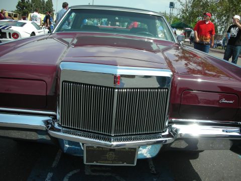 1992 Ford Crown Victoria - A maroon Lincoln Continental Mark V is displayed at a car show, with a Lincoln and Continental Owners Club plate on the front.