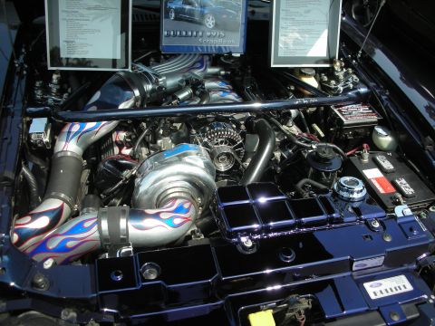 1992 Ford Crown Victoria - Customized engine bay a large turbocharger and intake piping adorned with blue flames.