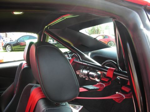 1992 Ford Crown Victoria - The interior of a car is shown, a roll cage and racing seats, with two other vehicles visible through the windows.