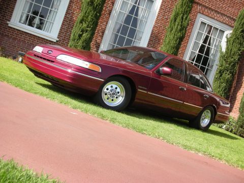 1992 Ford Crown Victoria - This sedan has a distinctive body style with chrome trim and aftermarket wheels.