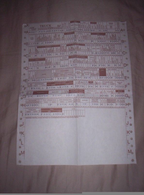 Red-ink printed 'TRUCK' parts reference sheet with lettered rows on tan fabric