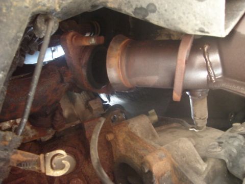 2000 Ford Crown Victoria - This image shows a section of a vehicle's exhaust system, likely a catalytic converter connection.