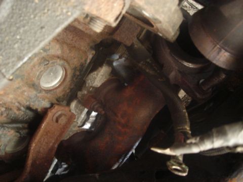 2000 Ford Crown Victoria - Close-up view of the exhaust system, likely showing a catalytic converter connection.