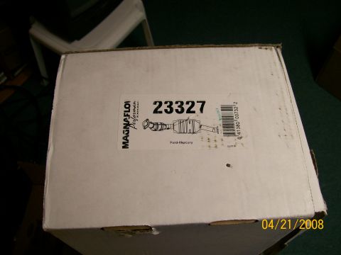 1995 Mercury Grand Marquis - A sealed white MagnaFlow Performance Exhaust carton sitting on green carpet, its label reading part number 23327 with a barcode and a line…