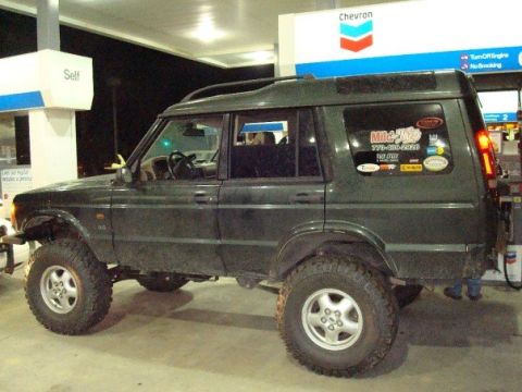 1995 Ford Bronco - This Land Rover Discovery II is parked at a Chevron gas station.