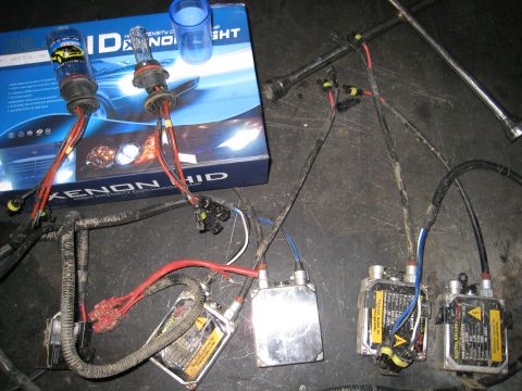 1996 Ford Bronco - Components of an HID Xenon headlight conversion kit are laid out, including bulbs and ballasts.