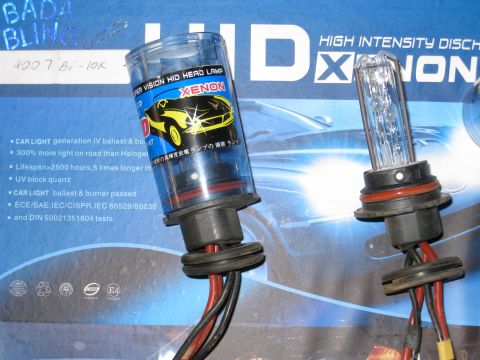 1996 Ford Bronco - HID Xenon headlamp bulbs are shown with detailed specifications on the packaging.