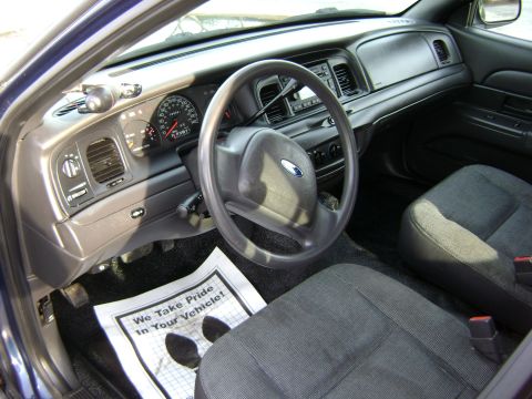 2001 Ford Crown Victoria - Interior view of a 2001 Ford Crown Victoria, showing the dashboard, steering wheel, and front seats.