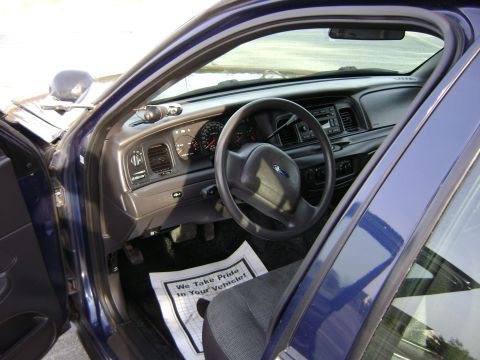 2001 Ford Crown Victoria - Interior view of a 2001 Ford Crown Victoria, the dashboard and driver's seat.