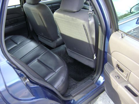 2001 Ford Crown Victoria - Rear interior view of a 2001 Ford Crown Victoria, highlighting the seats and door trim.