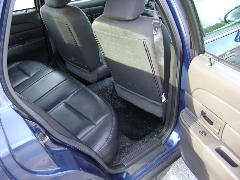 2001 Ford Crown Victoria interior showing rear leather seats and door panel