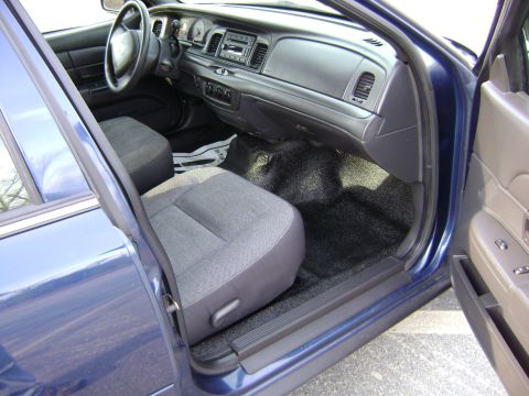 2001 Ford Crown Victoria - Interior view of a blue 2001 Ford Crown Victoria, showing the dashboard, steering wheel, and front seats.