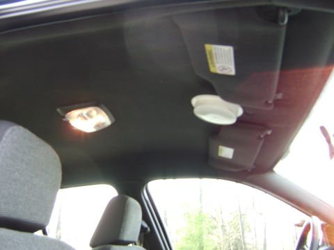 2001 Ford Crown Victoria - Interior shot showing the headliner, dome light, and sun visors of a vehicle.