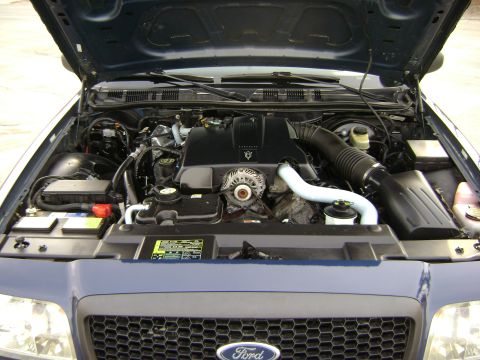 2001 Ford Crown Victoria - The engine bay of a 2001 Ford Crown Victoria, showing the engine, battery, and other components under the hood.