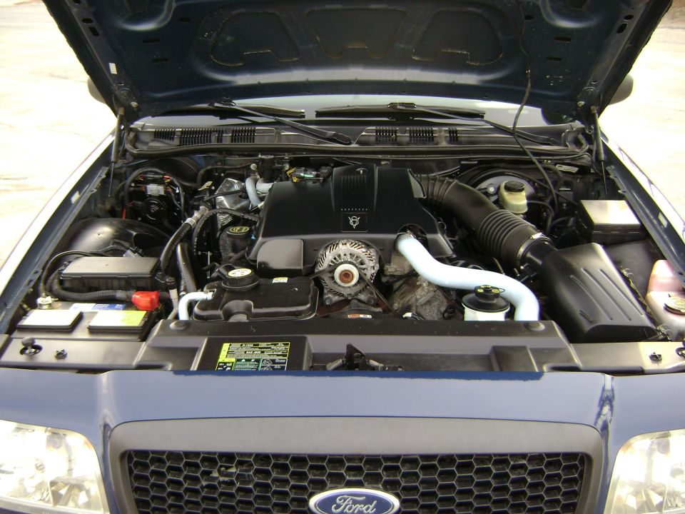 2001 Ford Crown Victoria engine bay with blue paint and black grille