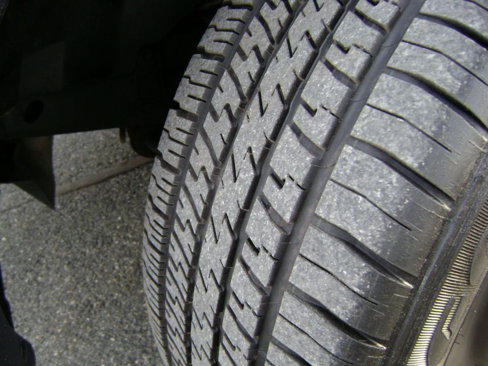 Close-up of a tire tread on asphalt