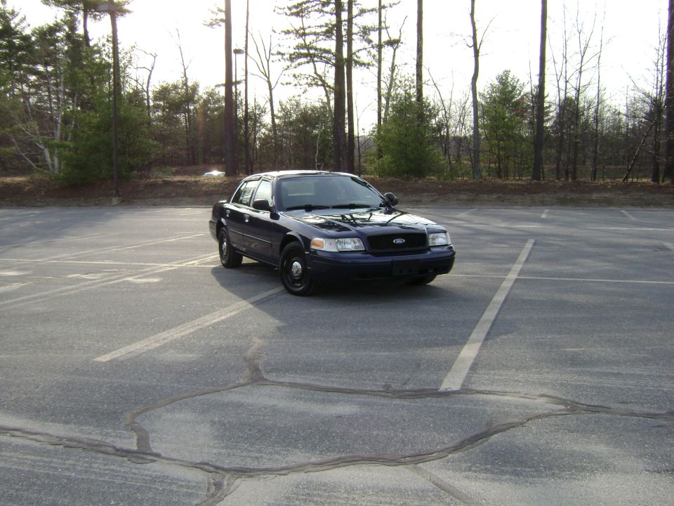 Dark blue 2001 Ford Crown Victoria parked in an empty lot