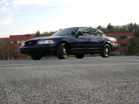 2001 Ford Crown Victoria - This Ford Crown Victoria is parked in front of an office building on a clear day.
