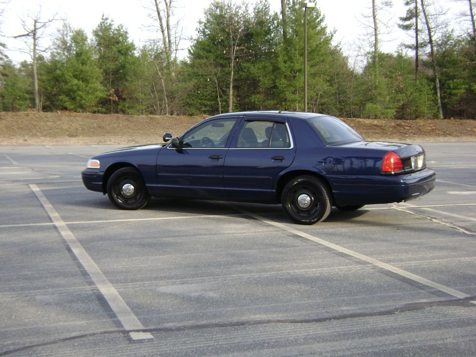 2001 Ford Crown Victoria police sedan parked in a lot, side view