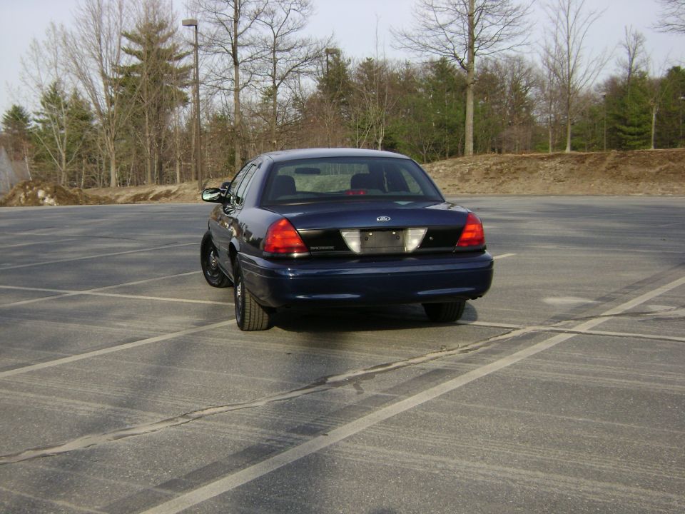 Dark blue 2001 Ford Crown Victoria rear view in a parking lot