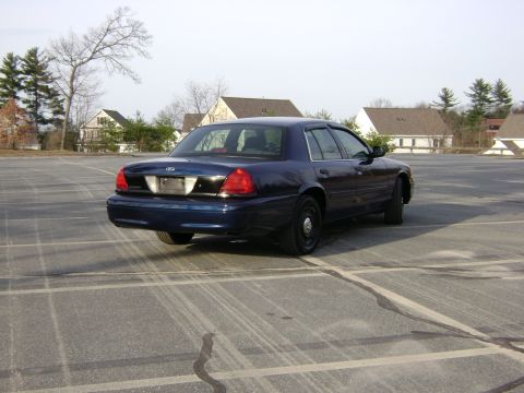 2001 Ford Crown Victoria - This Ford Crown Victoria is parked in an empty lot on a clear day.