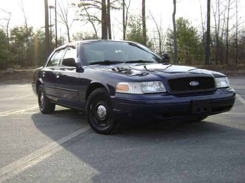 2001 Ford Crown Victoria - A dark blue 2001 Ford Crown Victoria is seen from the front quarter angle in a parking lot.
