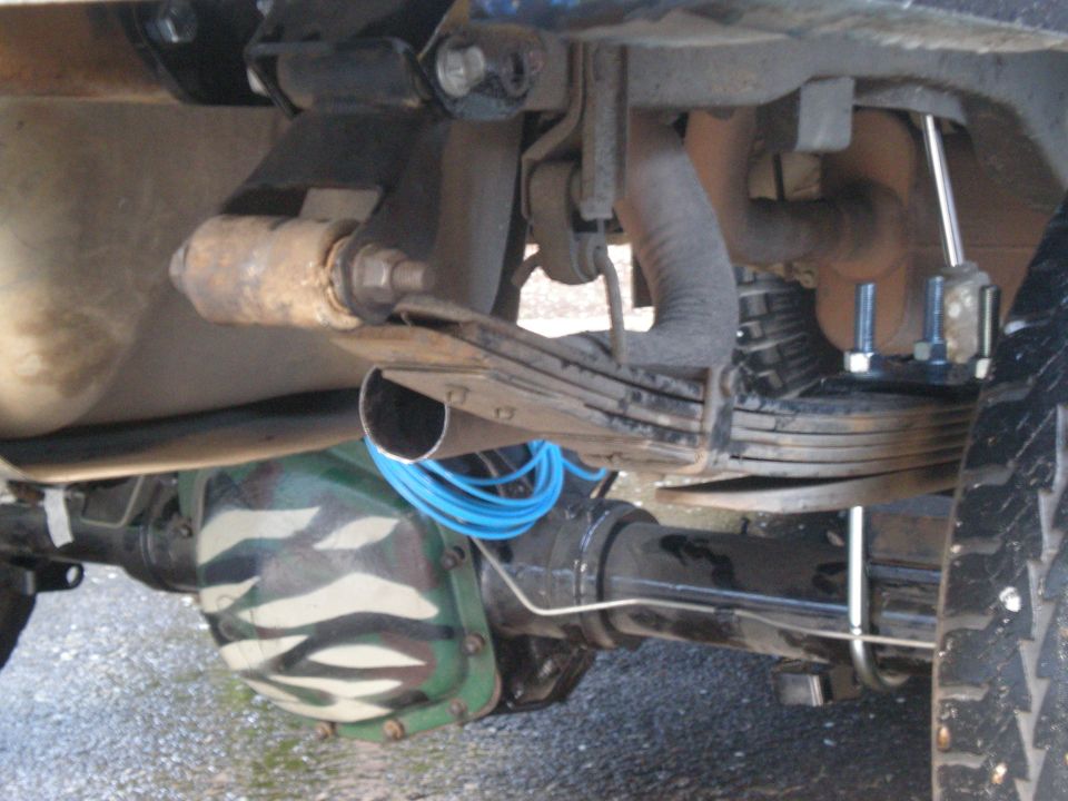 Rear axle with camouflage paint, leaf springs, and exhaust pipe