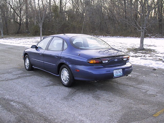 Blue 1996 Ford Taurus sedan parked on a road