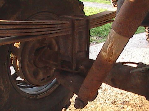 1980 Dodge Magnum - Close-up of the rear suspension components of a vehicle, showing significant rust.