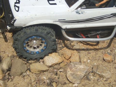 1988 Ford Bronco - Close-up of a modified RC rock crawler's wheel and side panel.
