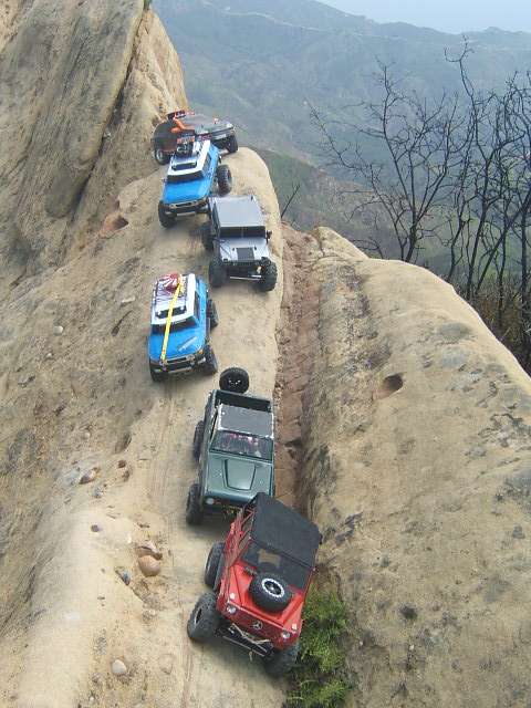 1988 Ford Bronco - RC vehicles navigate a challenging off-road course on a steep, rocky mountainside.