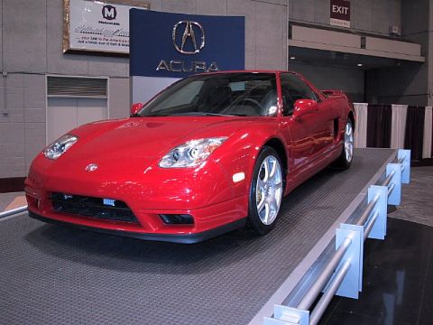 1996 Ford Taurus - Red Acura NSX sports car displayed at an auto show.