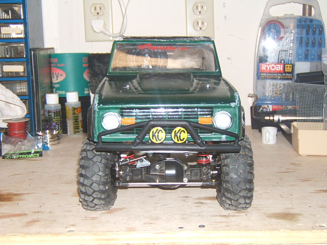 Green RC crawler truck front view with KC lights and large tires