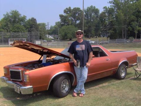 1979 Ford Ranchero - Orange 1977 Ford Ranchero with hood open, parked on grass with a man standing beside it.