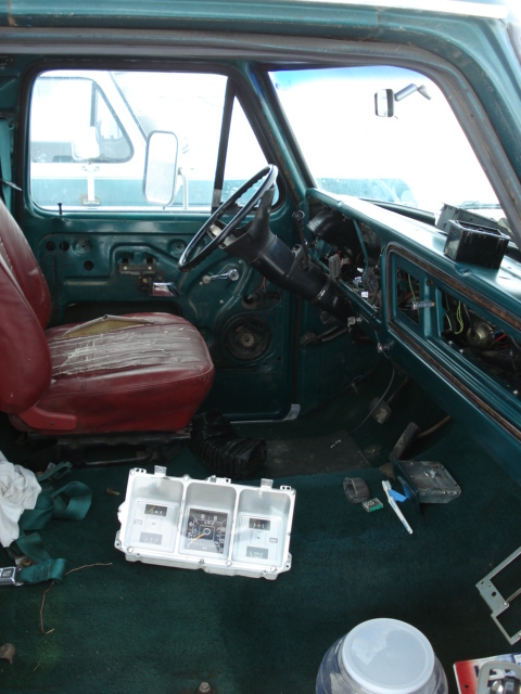 1979 Ford F-150 - The interior of a 1979 Ford F-150 shows a disassembled dashboard and worn seats.
