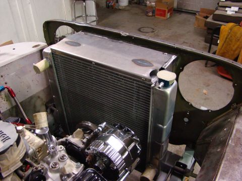 1948 Jeep Wrangler - Close-up of an engine and radiator assembly, likely undergoing restoration or modification.