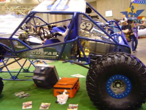 1979 Ford Bronco - Custom buggy with "CD FAB" lettering on the door, displayed indoors.