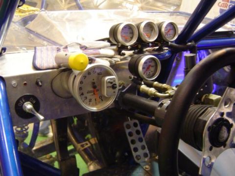 1979 Ford Bronco - The interior of a custom vehicle features a dashboard with multiple gauges and a tachometer.